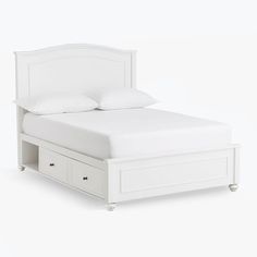 a white bed with two drawers underneath it and a pillow on the top of the headboard