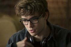 a young man wearing glasses and headphones