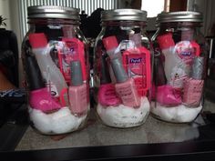 three mason jars filled with pink and white items