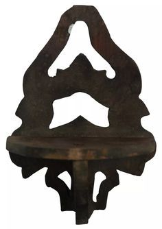 an iron shelf with two faces on it