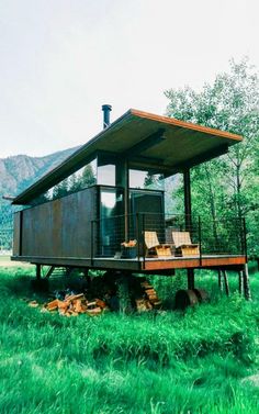 a small house sitting on top of a lush green field