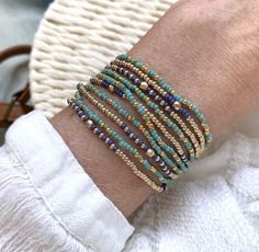 Beautiful Bohemian and colourful set of two wrap bracelets, both bracelets are handstrung on strong elastic cord and each wraps 5 times., also suitable to wear as a long necklace.  M A T E R I A L * Seed beads : gold plated ( 24 kt), turquoise, cobalt blue, champagne gold  seed beads * Extra strong elastic S I Z E * Size medium, 86 cm / 34 inch ( 17cm/6.8 inch when wrapped), fits the normal to small waist.  * Please sent me a message for other sizes, these bracelets can be made in any lenght (see faq for meas  S H I P P I N G  *  All orders are wrapped as a gift and shipped safely in a small letter box *  All orders above € 35 have free standard priority shipping (untracked) all orders above  € 150      will be upgraded to free  priority shipping with track  All jewelry in my shop is handm Jewelry Layering Necklace, Jewelry Layering, Blue Champagne, Bracelet Sets, Jewelry Diy Bracelets, Diy Bracelets Patterns, Beads Bracelet Design, Wrap Bracelets, Beaded Wraps