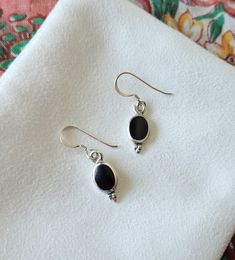 These elegant black dangle earrings are crafted of sterling silver and are lightweight for all day wear. - Simulated Black Onyx Inlay - Crafted of genuine sterling silver - 1/2" High (without hooks) and 1/4" Wide - Weight is about 2.1 grams Orders will ship out in 1-3 business days from my Arkansas studio. In addition to your jewelry, you'll receive a silver polishing cloth and art extra such as bookmark or mini print. Jewelry will be wrapped in anti-tarnish paper and placed inside a white box o Minimalist Black Sterling Silver Earrings, Classic Black Oval Earrings, Everyday Black Sterling Silver Earrings, Black Dangle Earrings For Everyday, Black Oval Pierced Earrings, Black Drop Earrings For Everyday, Everyday Black Drop Earrings, Black Sterling Silver Teardrop Earrings, Black Teardrop Sterling Silver Earrings