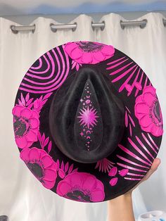 Halloween hat Brim is about 3.75" wide  Content: Vegan Suede Adjustable to fit your head better if needed  Elevate your style with this stunning hand-painted wide-brim fedora, crafted from luxurious vegan suede in a Vibrant Pink and Black palette. This one-of-a-kind piece is adorned with intricate designs featuring a flowers and vines winding gracefully around the crown, celestial stars, delicate leaves, The Sun and  phases of the moon. Each flower is meticulously painted with thick, textured strokes, adding a unique tactile dimension to the hat's sophisticated design. This fedora isn't just a hat; it's a wearable work of art. Perfect for making a statement at festivals, special events, or just adding a touch of magic to your everyday outfits. Whether you're dressing up or down, this versa Adjustable Flat Brim Halloween Hat, Adjustable Flat Brim Hat For Halloween, Adjustable Flat Brim Halloween Costume Hat, Fitted Fedora Costume Hat For Festivals, Fitted Brimmed Costume Hat For Festival, Adjustable Brimmed Felt Hat For Halloween, Halloween Adjustable Wide Brim Top Hat, Adjustable Fedora Felt Hat For Halloween, Halloween Wide Brim Top Hat