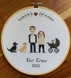 a cross stitch family portrait with their dog