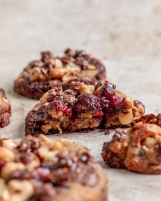 several cookies with cranberries and walnuts are on the table next to each other