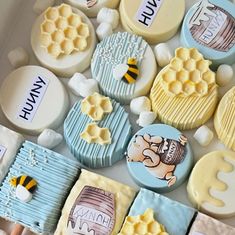 several decorated cookies in a box with bees and honeycombs