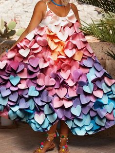 a woman wearing a colorful dress made out of paper hearts