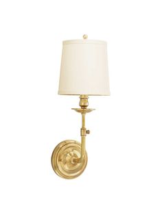 a gold wall light with a white shade on the top and bottom half of it