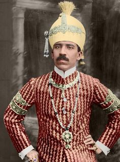 an old photo of a man wearing a red and white suit with a yellow hat