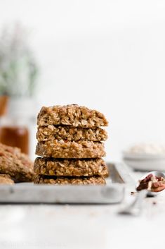 three cookies stacked on top of each other in front of a plate with spoons