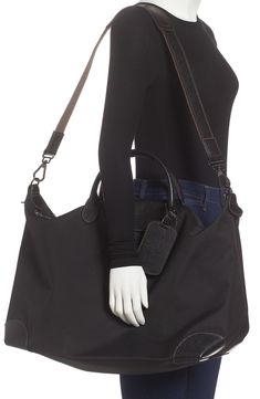 Trimmed with leather, this hard-wearing canvas travel bag is big enough for short business trips or weekend getaways but still small enough to take to the gym. Style Name:Longchamp Boxford Canvas & Leather Travel Bag. Style Number: 6087123. Black Leather Trim Duffle Bag For On-the-go, Black Leather Trim Weekender Satchel Bag, Black Travel Bag With Luggage Sleeve In Coated Canvas, Black Coated Canvas Travel Bag With Luggage Sleeve, Black Coated Canvas Travel Bag, Black Coated Canvas Bag With Luggage Sleeve, Black Leather Trim Luggage For Travel, On-the-go Weekender Bag With Leather Trim, Classic Coated Canvas Duffle Bag For On-the-go