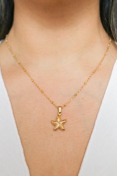 Introducing our Patricia Starfish Necklace, a charming piece inspired by coastal beauty. This necklace showcases a delicate starfish pendant, adding a subtle touch of seaside charm to your look. Versatile and understated, it's a lovely accessory for everyday wear, bringing a hint of coastal style to any outfit. All of our jewelry comes with a free jewelry pouch and cloth to keep your pretties safe and clean. Details Color: 18K Gold PlatedMaterial: Stainless SteelSize: 16in + 5cm extender Care Gu Yellow Gold Starfish Charm Jewelry For Beach, Elegant Starfish Charm Necklace For Beach, Ocean-inspired Necklaces With Star Charm, Dainty Star-shaped Necklace With Starfish Charm, Yellow Gold Star Necklaces With Starfish Charm, Ocean-inspired Jewelry With Star Charm, Dainty Starfish Necklace For Beach, Yellow Gold Starfish Charm Necklace For Beach, Yellow Gold Necklace With Starfish Charm For Beach