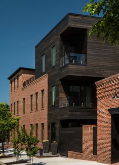 the building is made of wood and has balconies on each level that are connected to other buildings