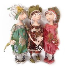 three dolls are standing next to each other