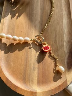 Details: * Gold: Brass/Stainless steel + 18K Gold plated * Natural freshwater pearls (9-10 mm); one grape/pomegranate pendant * No risk of allergy (nickel-free, lead-free, cadmium-free) * The shape and color of the pearls may vary * Size:  length 45 cm + 7 cm pendant * Delivered with a cleaning cloth and a ready-to-gift jewelry storage pouch * FREE USAVEL GIFT BOX +50e GIFT At checkout, you can send your selected items straight to your friend or loved one and also write a note and greetings from Grapes Jewelry, Grape Necklace, Pomegranate Necklace, Pomegranate Earrings, Pomegranate Jewelry, Fruit Necklace, Freshwater Pearl Necklace, Pretty Clothes, Jewelry Storage