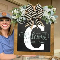 a woman is holding up a welcome sign