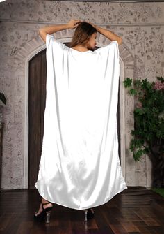 This long bottom cut kaftan is made up of satin material. A caftan is a perfect addition to any women’s wardrobe. It can be worn day into night, as a stunning swimsuit cover-up at the beach, as well as a glamorous evening dress Made from airy silk, it is cool and airy, and great for warm weather. this kaftan gives classy touch to your body line while carrying it. You can pair it with any kind of accessories at any occasion. You can carry it for the whole day without any trouble and fuss. This li Floor-length Satin Kaftan For Party, Evening Satin Maxi Kaftan, Satin Maxi Length Evening Kaftan, Evening Satin Maxi Length Kaftan, Silk Maxi Length Abaya, Satin Maxi Kaftan For Party, Floor-length Satin Kaftan For Eid, Satin Kaftan For Eid Party, Long Satin Maxi Dress For Summer