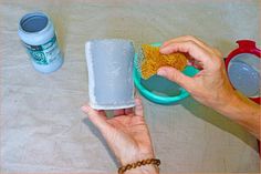 a person is cleaning their hands with a sponge and soap dispenser on the table