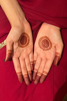 two hands with hendi designs on them