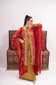 Discover luxury and elegance with our Red and Yellow Coat Shalwar Kameez. Made from plush materials, this front open poncho boasts intricate kundan work lace and resham tassels on each corner. The inner turmeric colored georgette silk shirt and pants add a touch of sophistication. Feel confident and stylish in this timeless piece. 3-Piece Suit Traditional Kaftan With Tassels, Designer Gold Velvet Dupatta, Traditional Long Sleeve Kaftan With Tassels, Festive Traditional Kaftan With Tassels, Bollywood Style Festive Kaftan With Tassels, Traditional Tassel Kaftan With Drape, Traditional Tasseled Kaftan, Bollywood Style Kaftan With Dupatta For Festivals, Elegant Gold Kaftan For Diwali