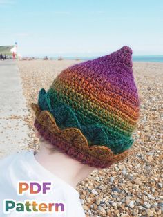 a child wearing a crocheted hat on the beach with text overlay that reads, free pattern