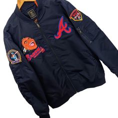 Atlanta Braves Commemorative Bomber Style Jacket Is Absolutely Fire! You Can Be The First To Own This Embroidered Commemorative Jacket Honoring Hank Aaron's 40th And 50th Anniversary Of His Remarkable 715th Home Run, Surpassing The Great Babe Ruth's Long Standing Record! The Bomber Style Jacket Is Made Of High-Quality,Military Grade, Tough Nylon Material And Will Last You A Very Long Time. Reward Yourself With This Gorgeous Special Edition Jacket. Size Xl Form Fit But Not Too Tight High-Grade Ny Blue Long Sleeve Outerwear With Embroidered Graphics, Blue Outerwear With Embroidered Patch For Fall, Fall Blue Outerwear With Embroidered Patch, Blue Long Sleeve Outerwear With Embroidered Patch, Blue Winter Outerwear With Embroidered Patch, Blue Embroidered Winter Outerwear, Hank Aaron, Babe Ruth, Reward Yourself