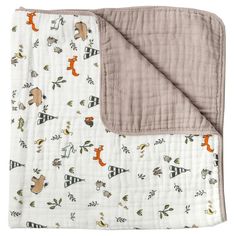 a baby blanket with animals on it and a brown border around the edges is shown