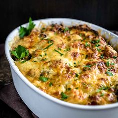 a casserole dish with cheese and herbs