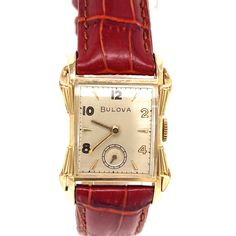 This vintage Bulova Ambassador (or Everett) watch has a 10K gold-filled case with a dial consisting of gold foiled numerals and embossed hour markers, gold tone sword hands, and a small subsidiary dial with a sweeping gold seconds hand. The date code of L2 on the outside back case dates this watch to 1952.  This beautiful Art Deco watch case features a scalloped bezel and fancy lugs and is quadruple signed by Bulova. The case measures approximately 26mm wide x 36mm from lug end to lug end. Benea Antique Yellow Gold Watches For Business, Classic Collectible Watch With Rectangular Dial, Classic Watches With Rectangular Dial For Collectors, Vintage Yellow Gold Watch With Rectangular Dial, Antique Gold Watches With Subdials, Antique Formal Watches With Subdials, Antique Gold Watch For Business, Antique Quartz Business Watches, Retro Gold Rectangular Watches