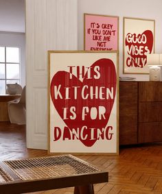 there are posters on the wall in this kitchen that say, this kitchen is for dancing