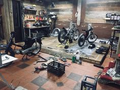 a garage filled with lots of different types of bikes and tools on the floor next to each other