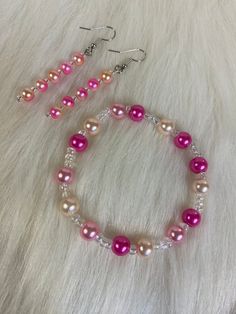 Hi Everyone, 🌸💖 Pink is for you, 🌸💖 Handmade Earrings & Bracelet Set, Pink, White Beads, Silver Dangle Earrings, Stretch Bracelet. Handmade fashion jewelry accessories perfect gifts for her.  Can be for everyday custom made look for women. Perfect earrings for spring and summer. The length is about 2.5 inches from top to bottom . The bracelet is 7.5 inch stretch.  Thank you for looking at my jewelry shop. White Bracelet Beads, Henderson Nv, Handmade Fashion Jewelry, White Bracelets, Silver Dangle Earrings, Beaded Bracelets Diy, Beaded Accessories, Bracelet Crafts, Pretty Earrings