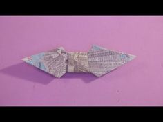 an origami bow on a purple background