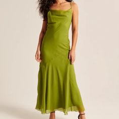 a woman in a green dress posing for the camera