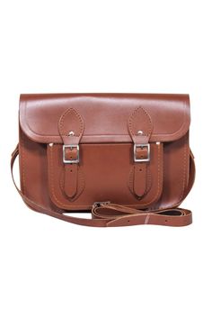 Upgrade your weekend wardrobe with this polished bag from The Cambridge Satchel Company. Crafted from luxe leather in a versatile brown, this stylish satchel adds a sophisticated charm to any look. An adjustable shoulder and chic buckled pocket complete this satchel, making it the perfect companion for your next adventure. Leather Front buckle closure Small front pocket Adjustable shoulder strap Discreetly embossed w/ logo on back Nickel hardware Small white mark on bottom Tiny mark on front at pocket trim Tiny blemish on front Width 10.75" Height 7.75" Depth 1.75" Strap drop 19-25" Travel Satchel Saddle Bag With Buckle Closure, Travel Saddle Bag With Buckle Closure, Timeless Brown Satchel Bag, Office Satchel Shoulder Bag With Buckle Closure, Luxury Leather Satchel With Buckle Closure, Brown Crossbody Office Satchel, Luxury Rectangular Satchel With Buckle Closure, Brown Crossbody Satchel For Office, Classic Shoulder Bag With Buckle Closure