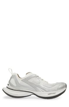 Balenciaga's exaggerated proportions define a track-style sneaker designed with a springy, bulbous heel and a raised, rubberized logo at the back. Lace-up style Textile and synthetic upper and lining/rubber sole Imported Designer Shoes White Functional Running Shoes With Studded Outsoles, Modern Silver Running Shoes, Modern Silver Running Sneakers, Silver Running Shoes With Translucent Outsole For Streetwear, Sporty Silver Running Shoes With Translucent Outsole, Sneaker Men, Designer Sneakers, Up Styles, White Silver