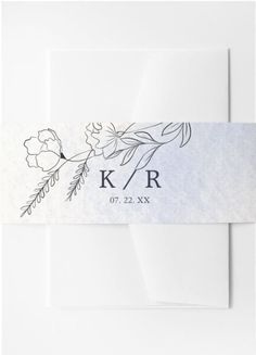 a white envelope with the initials k / r on it and flowers in black ink