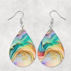 a pair of earrings with an abstract design on the front and back of each ear