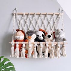 several stuffed animals are hanging on a macrame