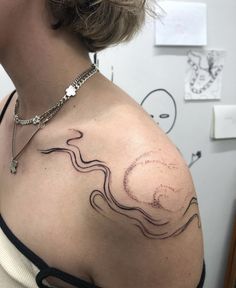 a woman with a tattoo on her shoulder