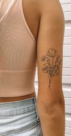 a woman with a flower tattoo on her arm