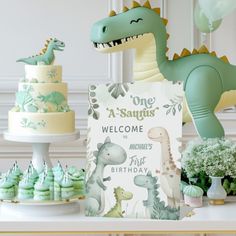 a dinosaur themed birthday party with cake, cupcakes and decorations