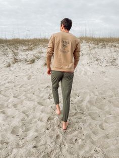 Man on beach wearing Frond Clothing Co sweatshirt Casual Sweats For Lounging, Casual Cotton Sweatshirt For Lounging, Casual Cozy Fit Sweatshirt For Lounging, Casual Crew Neck Sweatshirt For Lounging, Comfortable Cotton Sweatshirt For Lounging, Relaxed Fit Cotton Sweatshirt For Weekend Wear, Casual Sweatshirt For Loungewear, Casual Comfortable Sweatshirt For Loungewear, Comfortable Casual Sweatshirt For Loungewear