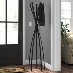 a coat rack stands next to a door