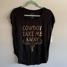 Nwt Project Karma Top. New With Tags! - Size: Medium - Gold Writing Says “Cowboy Take Me Away”. - 95% Rayon, 5% Spandex Measurements: Pit To Pit: 19.5”. Shoulder To Hem: 26.5”. Smoke Free Home. Offers Welcome! Note: All Measurements Are Taken While Garment Is Laying Flat. Measurements Are Approximate. Bin E Black Top For Spring Rodeo, Black Western Tops For Summer, Black Western Style Summer Tops, Black Western Style Tops For Summer, Black Western Top With Graphic Print, Trendy Black Tops For Rodeo, Welcome Note, Gold Writing, Cowboy