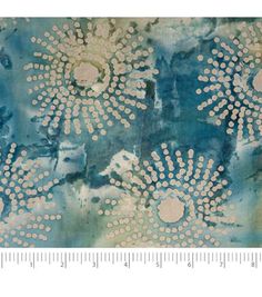 a blue and white fabric with flowers on it, in the middle of a ruler