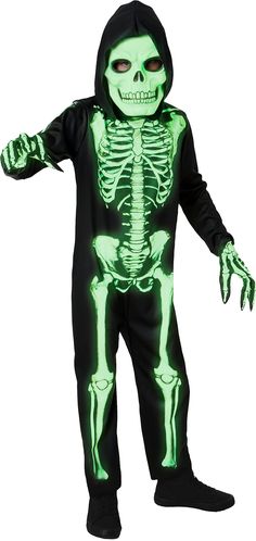 a boy in a skeleton costume with glowing green eyes and arms, holding his hands out