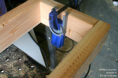 a piece of wood being worked on by a pair of pliers and a vice