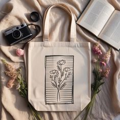 Need a holiday gift idea or a simple thoughtful gift? Elevate your everyday style with our exquisite Floral Line Art Tote Bag!  Perfect for line art lovers seeking a chic canvas to express their passion, eco-conscious shoppers looking for sustainable yet stylish options, and busy students or professionals who need a versatile bag for books and laptops. Grab yours today and bloom wherever you go! ‣ Tap here to head back to the shop: https://www.etsy.com/shop/FukuDesignsUS ‣ Follow us on: IG - htt Artistic Beige Bags For Gifts, Artistic Beige Bags Perfect For Gifts, Line Art Lovers, Bag For Books, Flower Print Design, Floral Tote Bag, Painted Tote, Art Tote Bag, Design Line